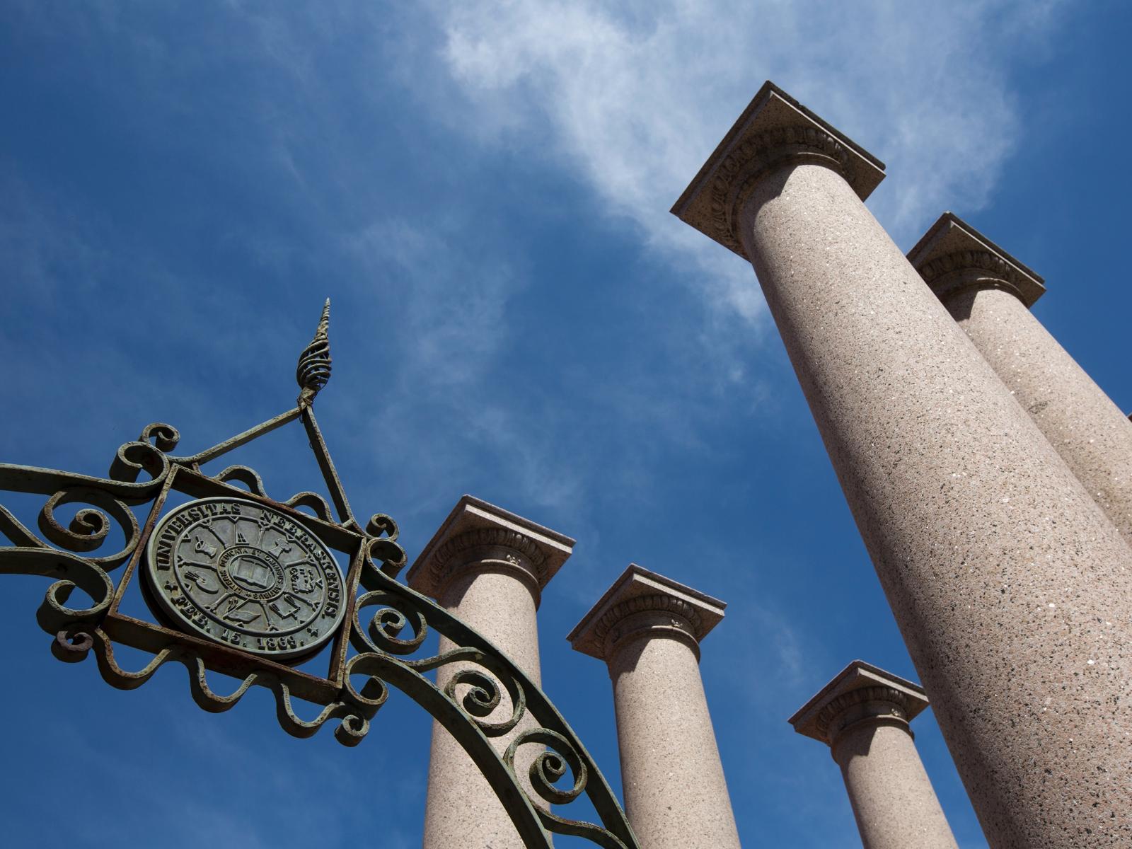 Granite columns and blue sky on campus.
