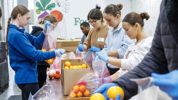 University of Nebraska–Lincoln students place oranges into bags during SLICE’s Engage Lincoln volunteer project at the Food Bank of Lincoln on Jan. 30. [Jordan Opp | University Communication and Marketing]