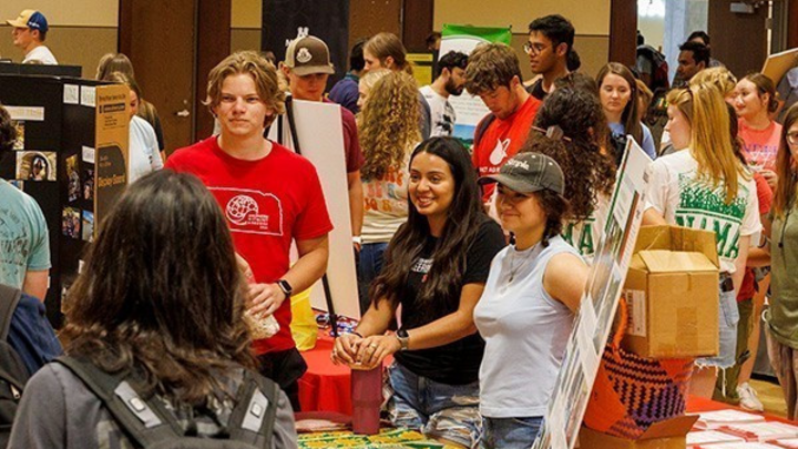 Students mingle and visit with recognized student organization (RSO) members during an Nvolvement Fair.