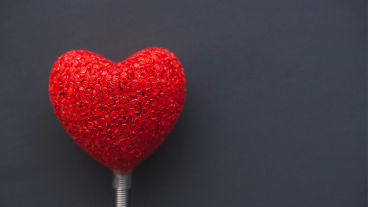 big red heart on dark background. [pexels]