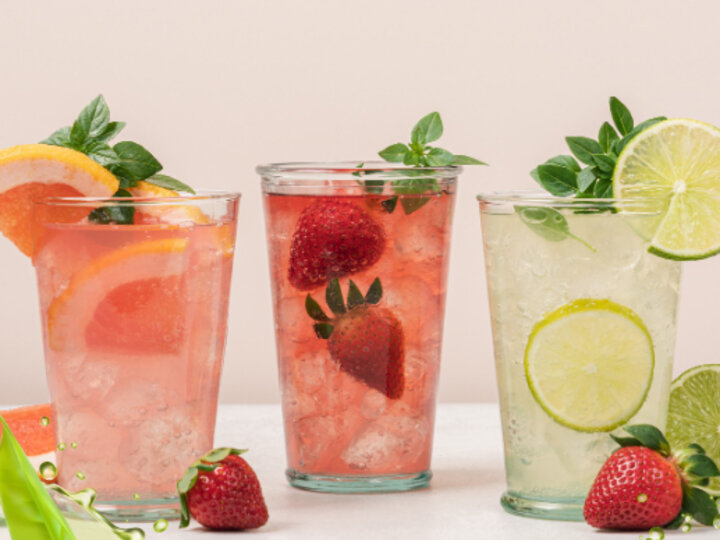 Three drinking glasses with fruit-flavored iced teas.