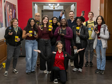Eleven individuals pose together as the inaugural inductees in to the Popcorn Pop-Up's Golden Kernel Club. November 13, 2025.